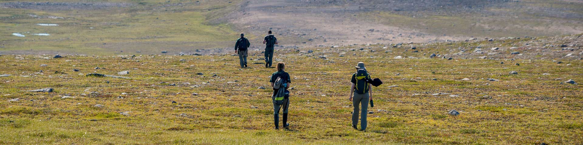 Staff members of Parks Canada hiking in Ukkusiksalik National Park.