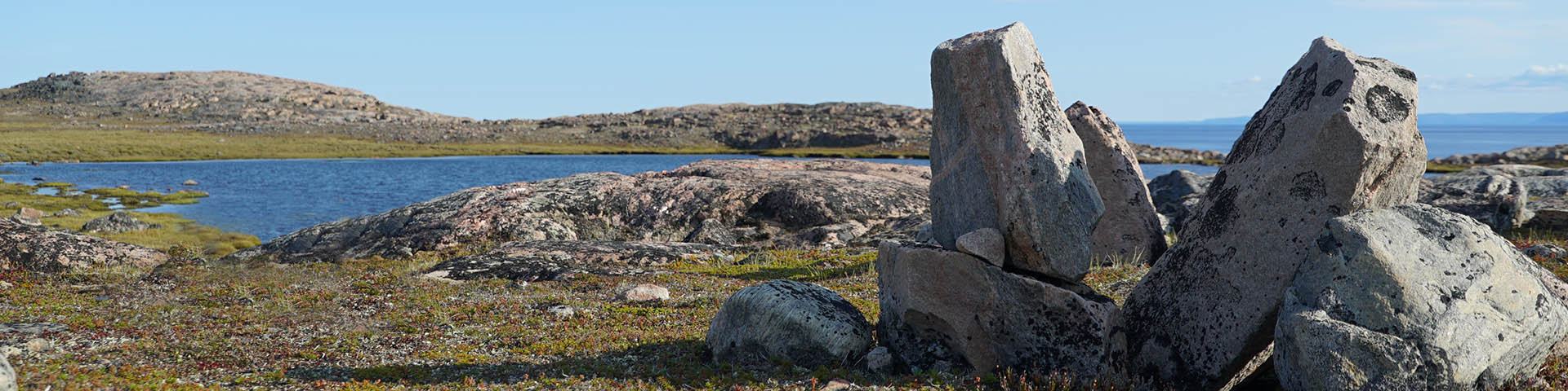 A rock structure surrounded by tundra scenery. 
