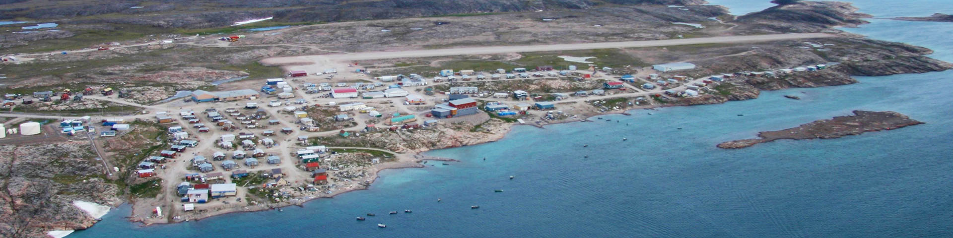 An aerial view of a small community next to the water. 