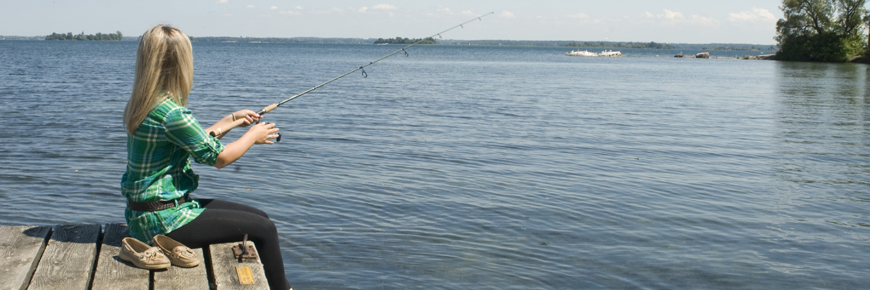 A women fishing off a dock