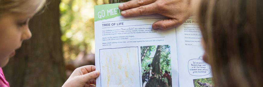 A mother and daughter complete some activities in their xplorers booklet. 