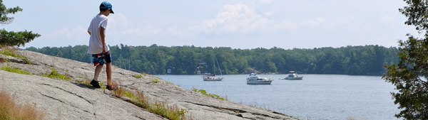 Boy standing on a rock