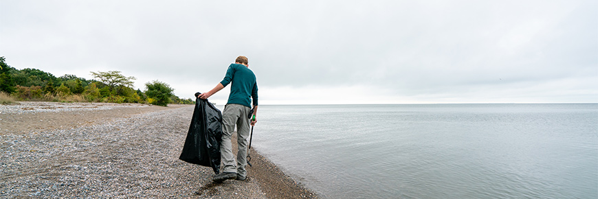 Parks Canada staff member picking up litter at Point Pelee
