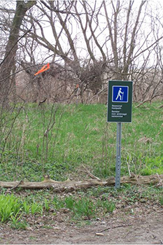 seasonal birding footpath marked with orange flagging tape
