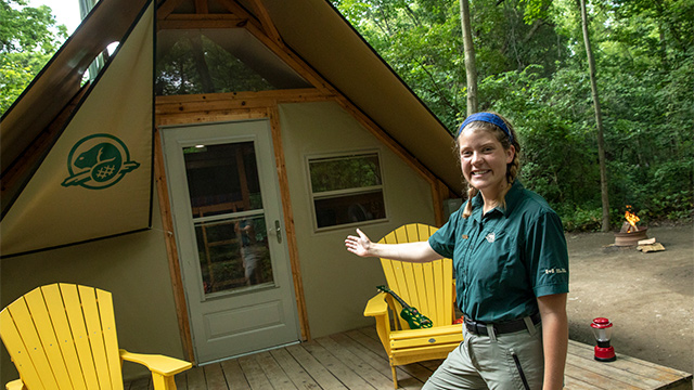 Parks Canada staff members stands welcoming to an oTENTik