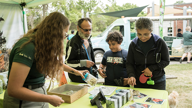 A Parks Canada staff member speaks to visitors at an event