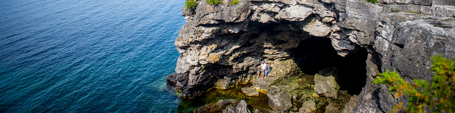 A rock cave on the shoreline.