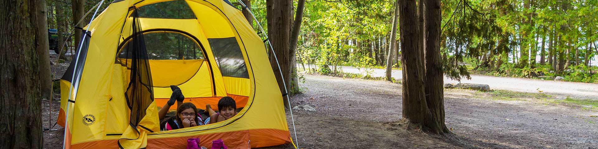 Two kids in a tent. 