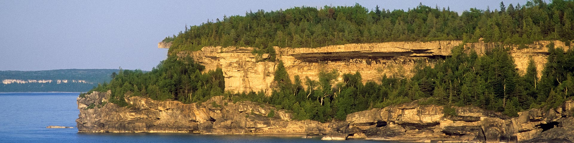 A rocky cliff along the shoreline.