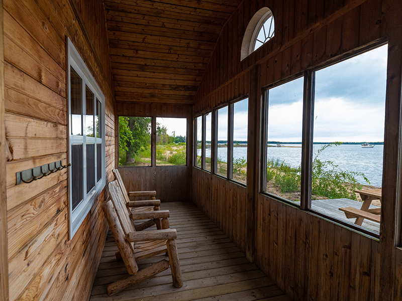 A screened in area with chairs