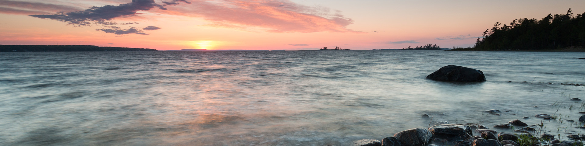 A shoreline at sunset. 