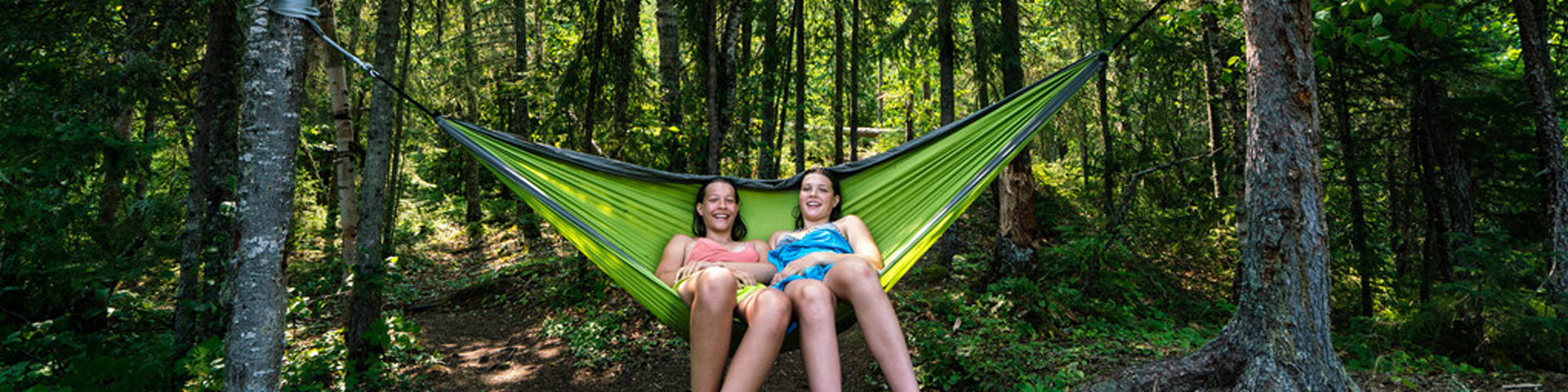 Two girls sitting in a hammock.