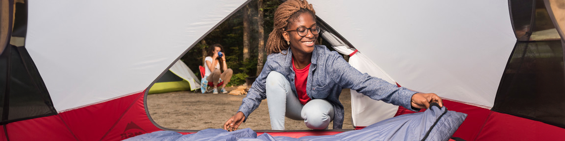 A woman setting up her tent.