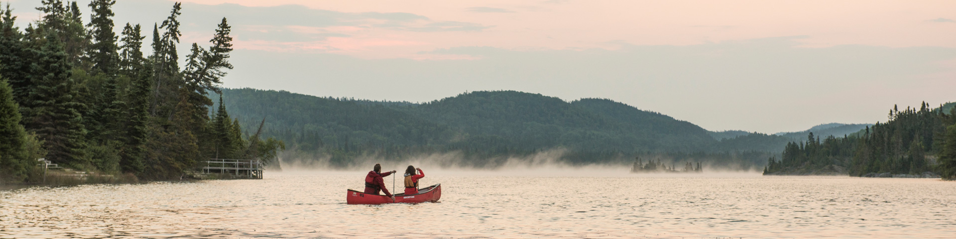 A couple on a canoe in Hattie Cove