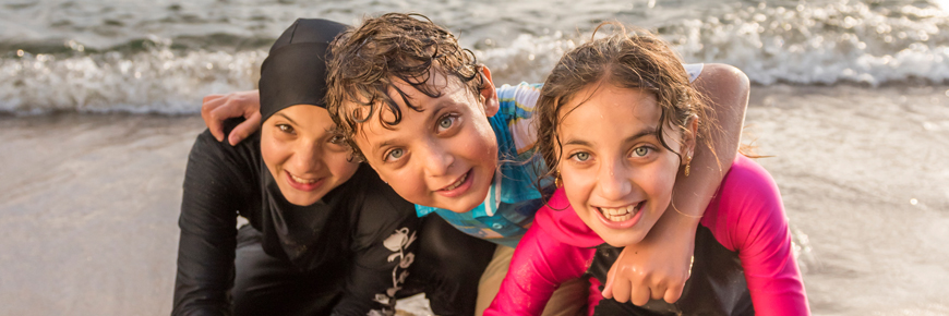 Three children on the beach.