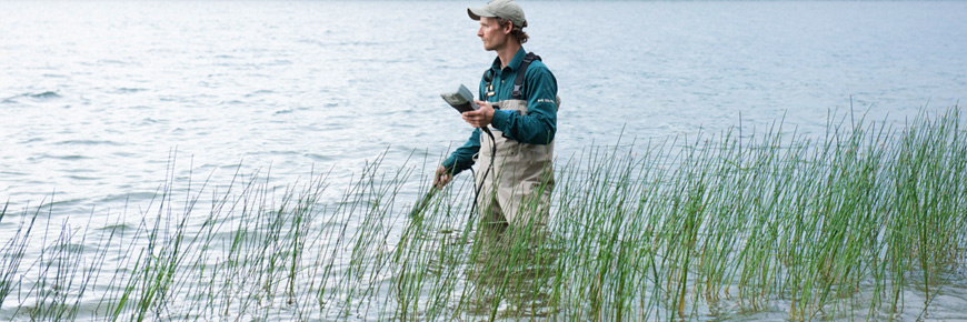 A person wading in a lake.