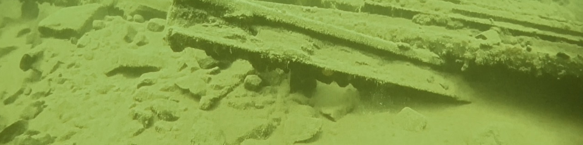 A screen capture from the ROV Ursula showing a ghostly image of rail stock and debris likely from a previous train derailment