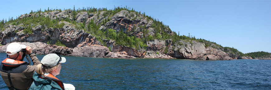 Two people on Lake Superior looking at the shoreline.