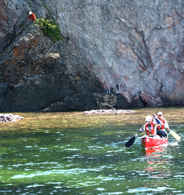 Dr. Brian Ratcliff and Frank Pianka return to the Wild Shore from a nest near Cascade Falls with the falcon chicks for banding and blood sampling. Climber Rodney Swatton remains at the nest to safely receive the chicks upon their return.