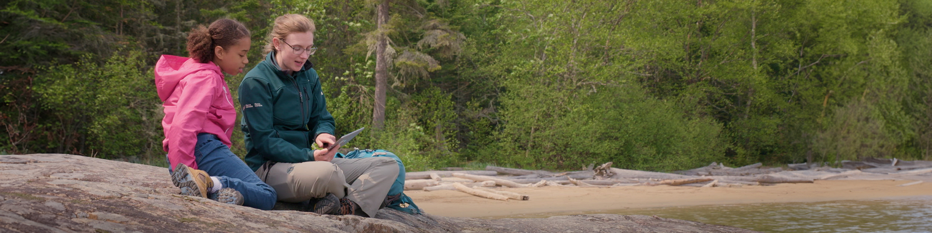 Courtney shows Taviss on a tablet how she can access data from remote sensing Copyright: © Fifth Ground Entertainment