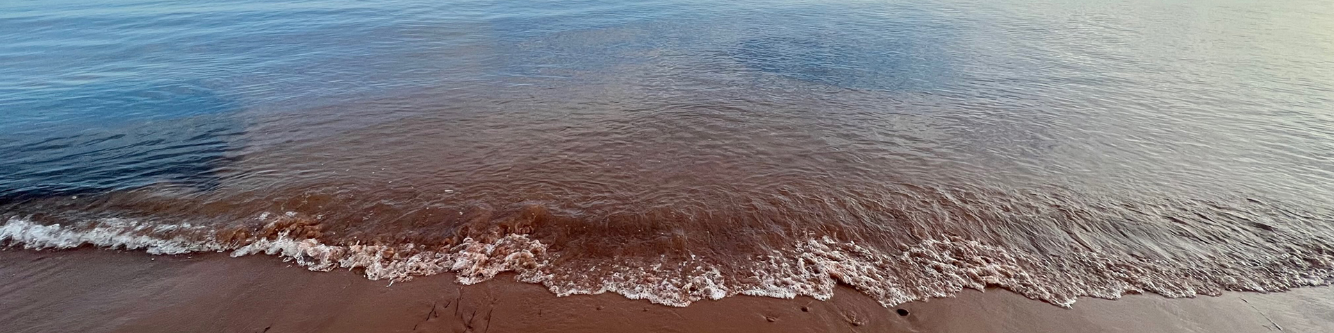 calm waves crash onto the sand