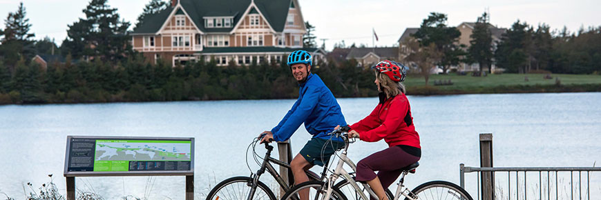 Two cyclists ride past Dalvay-by-the-Sea National Historic Site on the Gulf Shore Way East. 