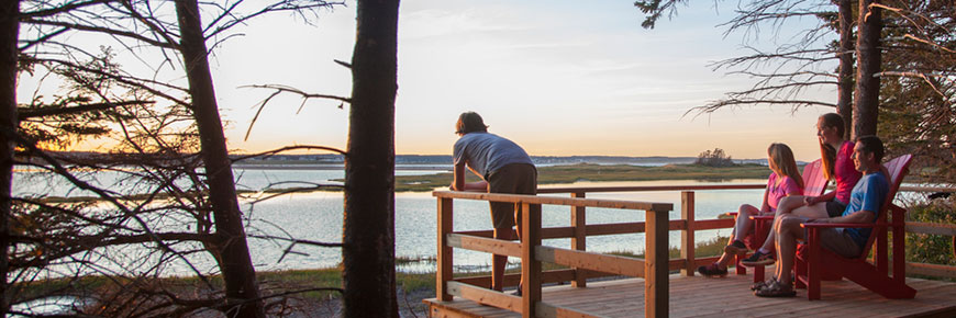 A group stops at a lookout point on the Robinsons Island Trail System at sunset. 
