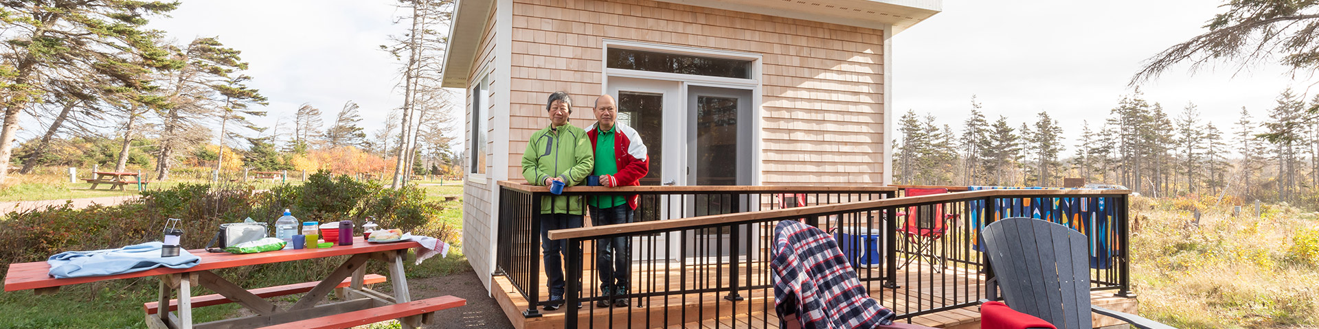 Two people standing in front of a bunkie