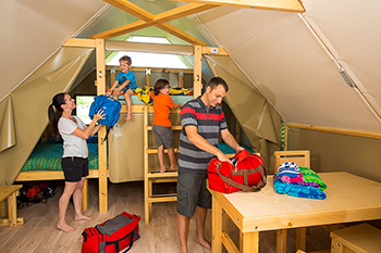 A family sets up their gear inside an oTentik