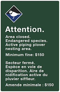 Beach closure sign that says: Attention. Area closed. Endangered species. Active piping plover nesting area. Minimum fine: $150.