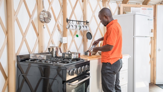A man is cooking on a counter.