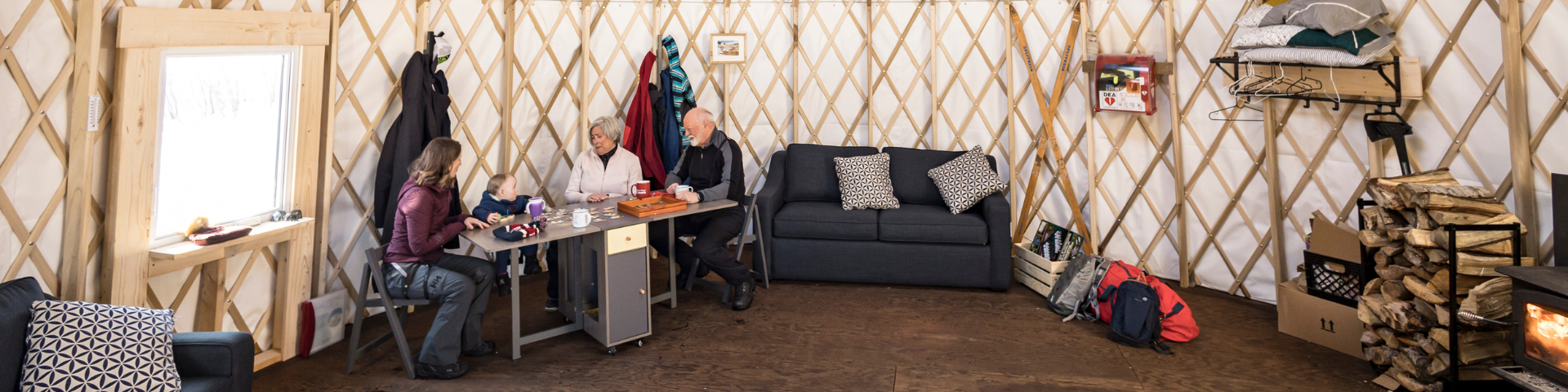 A family plays a board game on a table.
