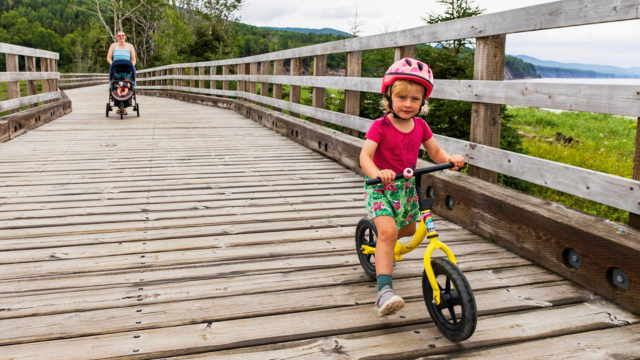 A child rides her training bike on the Penouille boardwalk.