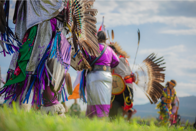 Group of mi'gmak dancers in traditional outfits