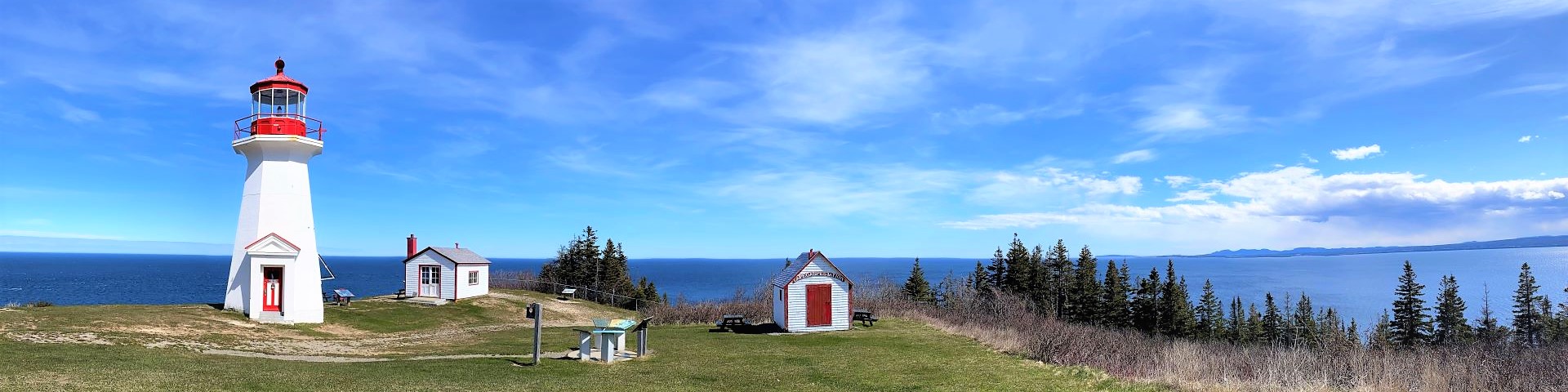 Panoramic view of a lighthouse and buildings.
