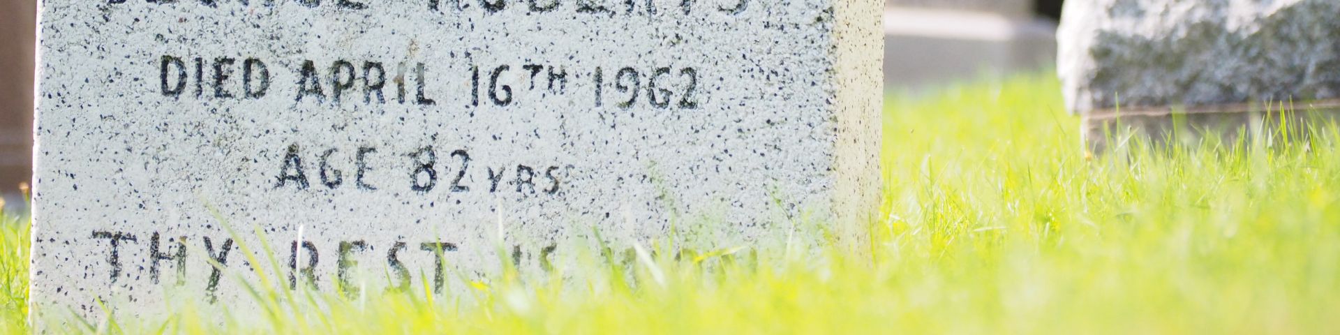 Part of a tombstone and grass. 