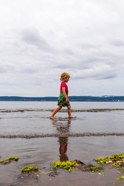 A child walks on the Penouille sandy beach.