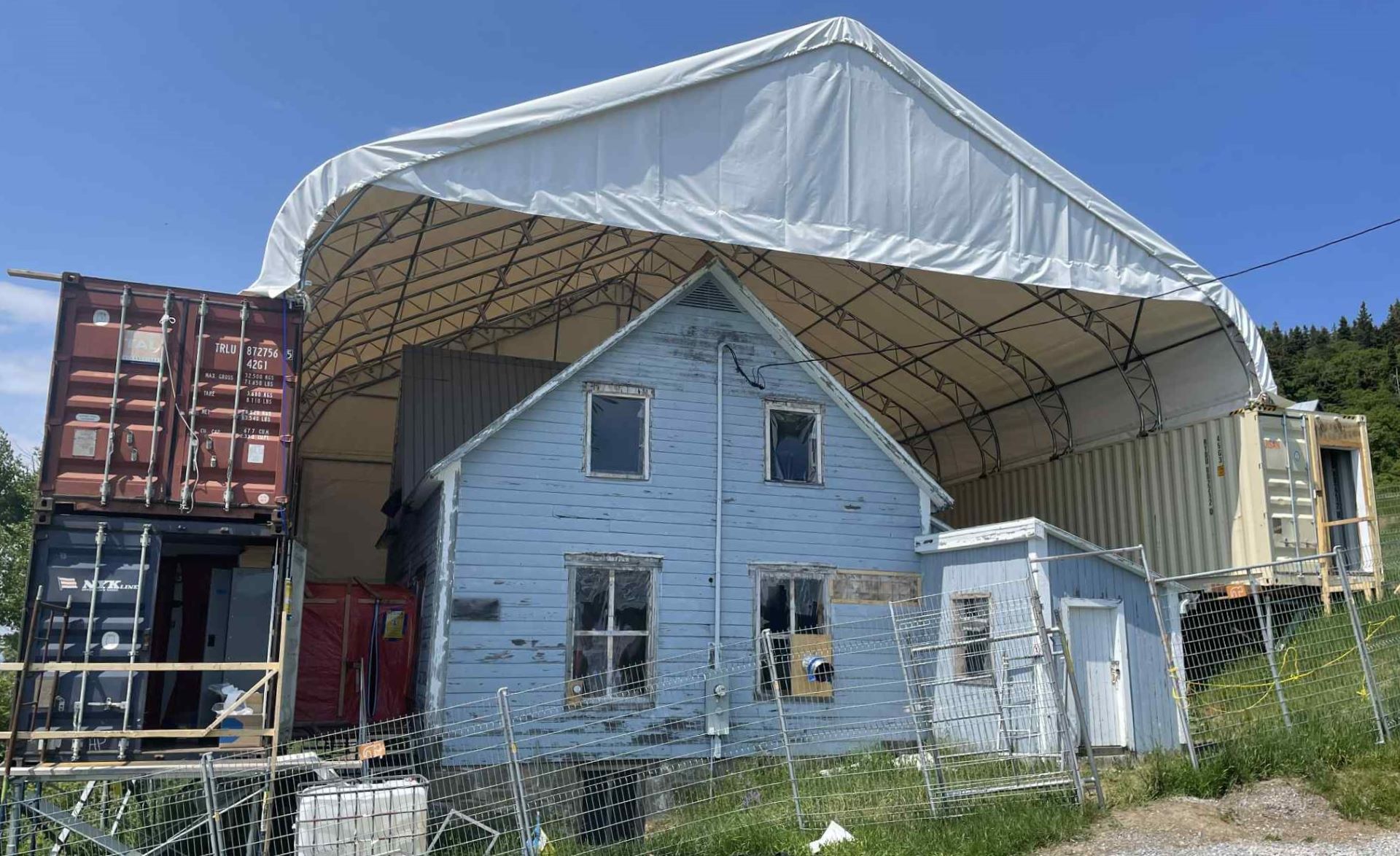 Blue house under a dome in a construction work area. 