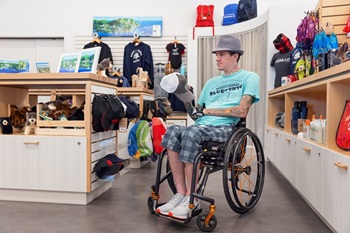 A man in a wheelchair is shopping at a Parks Canada shop