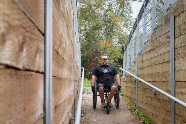 A man in a wheelchair in a defence battery tunnel.