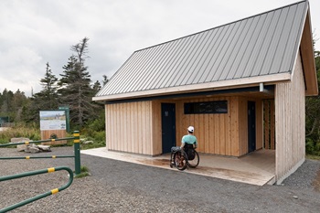 A man in a wheelchair at the entrance of a service building