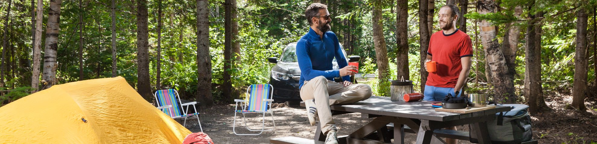 Four campers enjoy the moment, in autumn, in front of a campfire. 