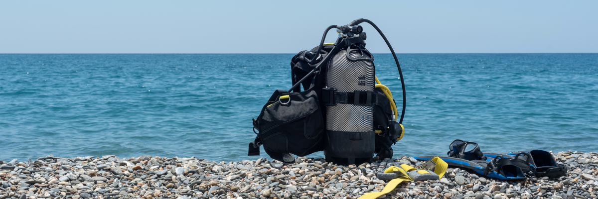 Scuba diving equipment like oxygen bottle and palms.