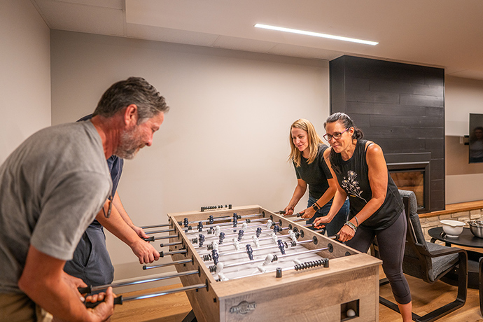 Visitors playing baby-foot in the basement.