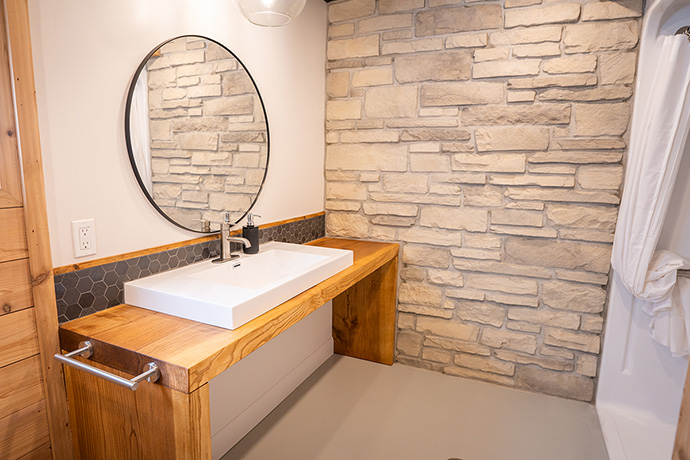 Bathroom. Vanity and an oval mirror.