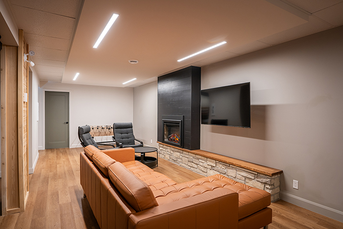 Basement with artificial fireplace.