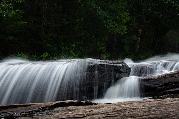 Water cascades down a rock face.