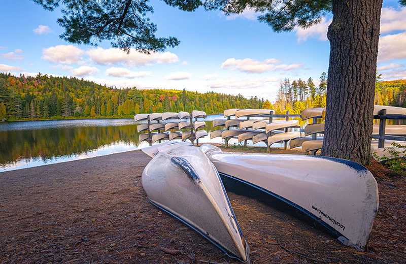 Two canoes upside down on the sand.