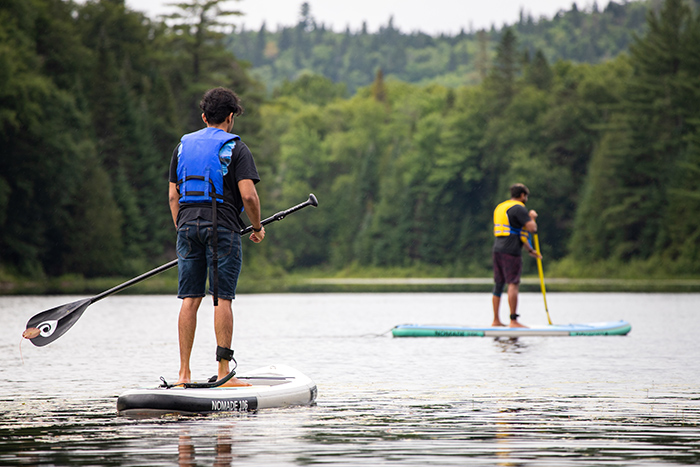Two paddleboarders on a lake.
