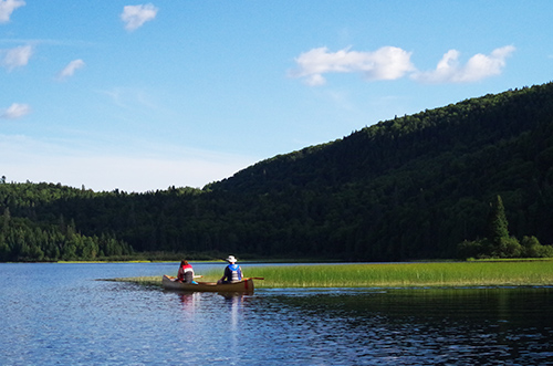 A couple canoeing on a calm lake